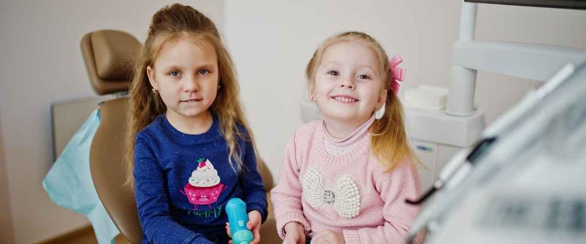 Split image of two smiling girls. Left: young girl in yellow in a bright room. Right: older girl in blue beanie outdoors with fall leaves. Cheerful mood.