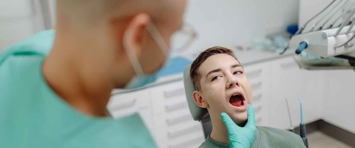 Split image of two smiling girls. Left: young girl in yellow in a bright room. Right: older girl in blue beanie outdoors with fall leaves. Cheerful mood.